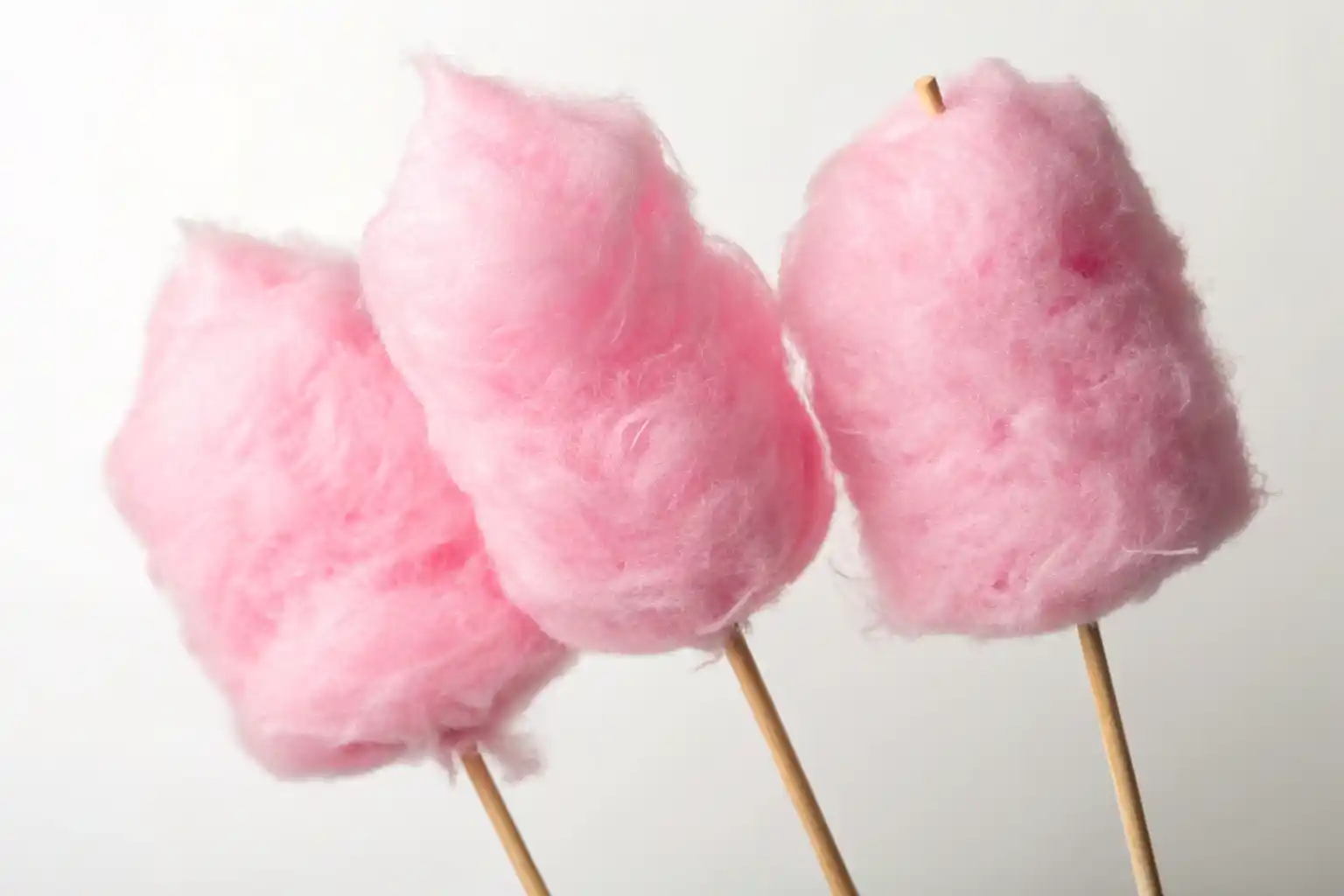 Pink cotton candy being spun on a cotton candy machine