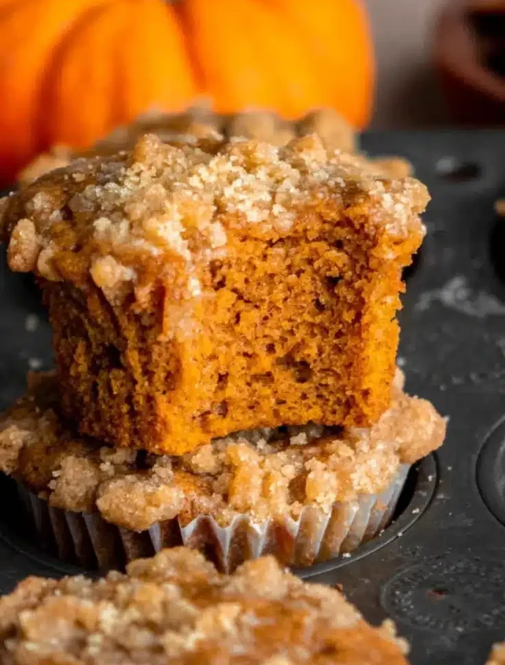 Delicious Pumpkin Streusel Muffins fresh out of the oven with a crunchy topping.